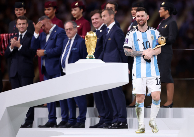 Lionel Messi holding the World Cup trophy.