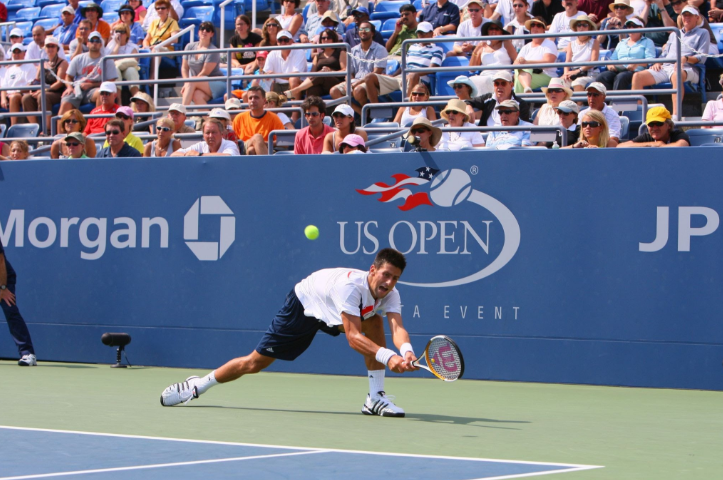 Djokovic battling on court during a major tournament.