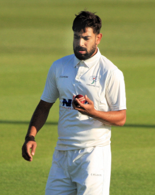 Professional fast bowler Haris Rauf in dynamic action during a premier domestic red-ball fixture.