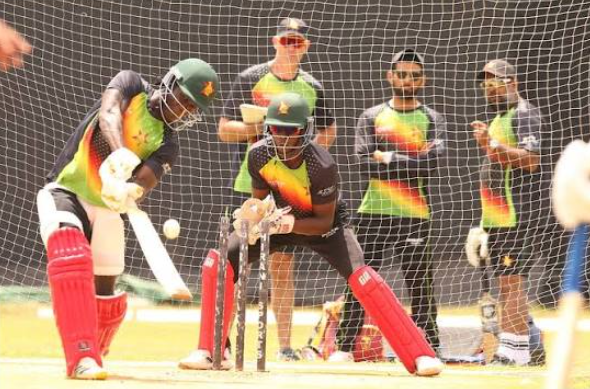 Zimbabwean cricket player practicing batting strokes in the nets.